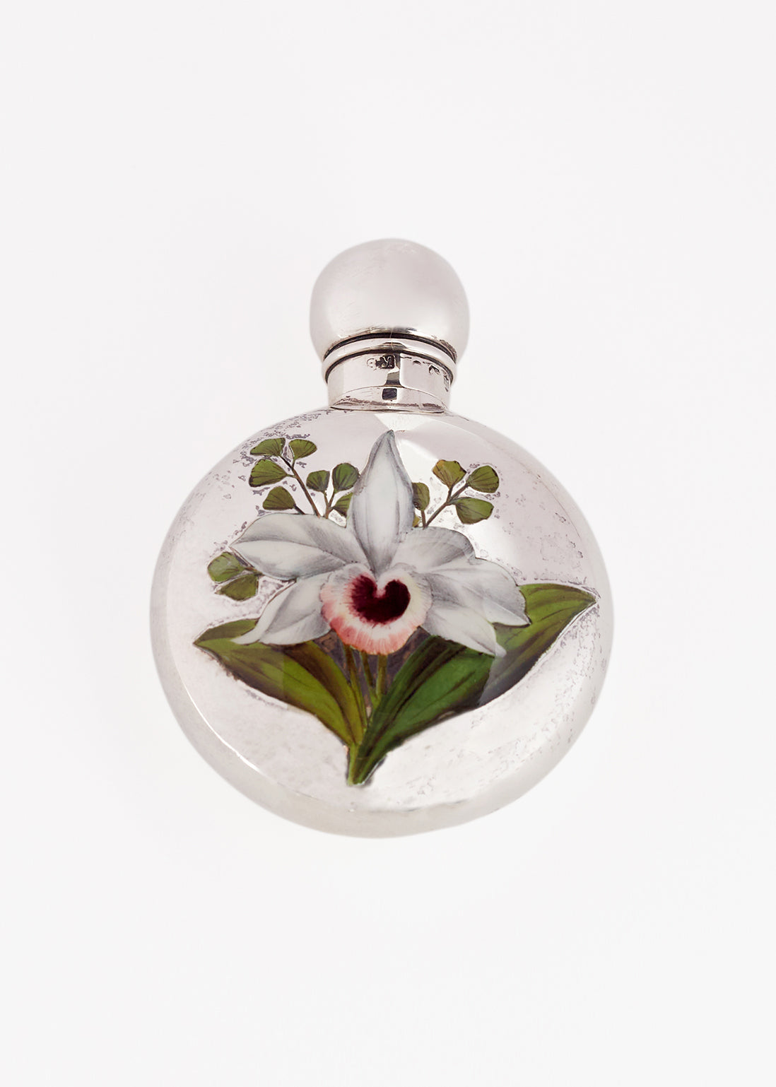 Close up image of Victorian silver bottle for perfume. Silver with floral motif