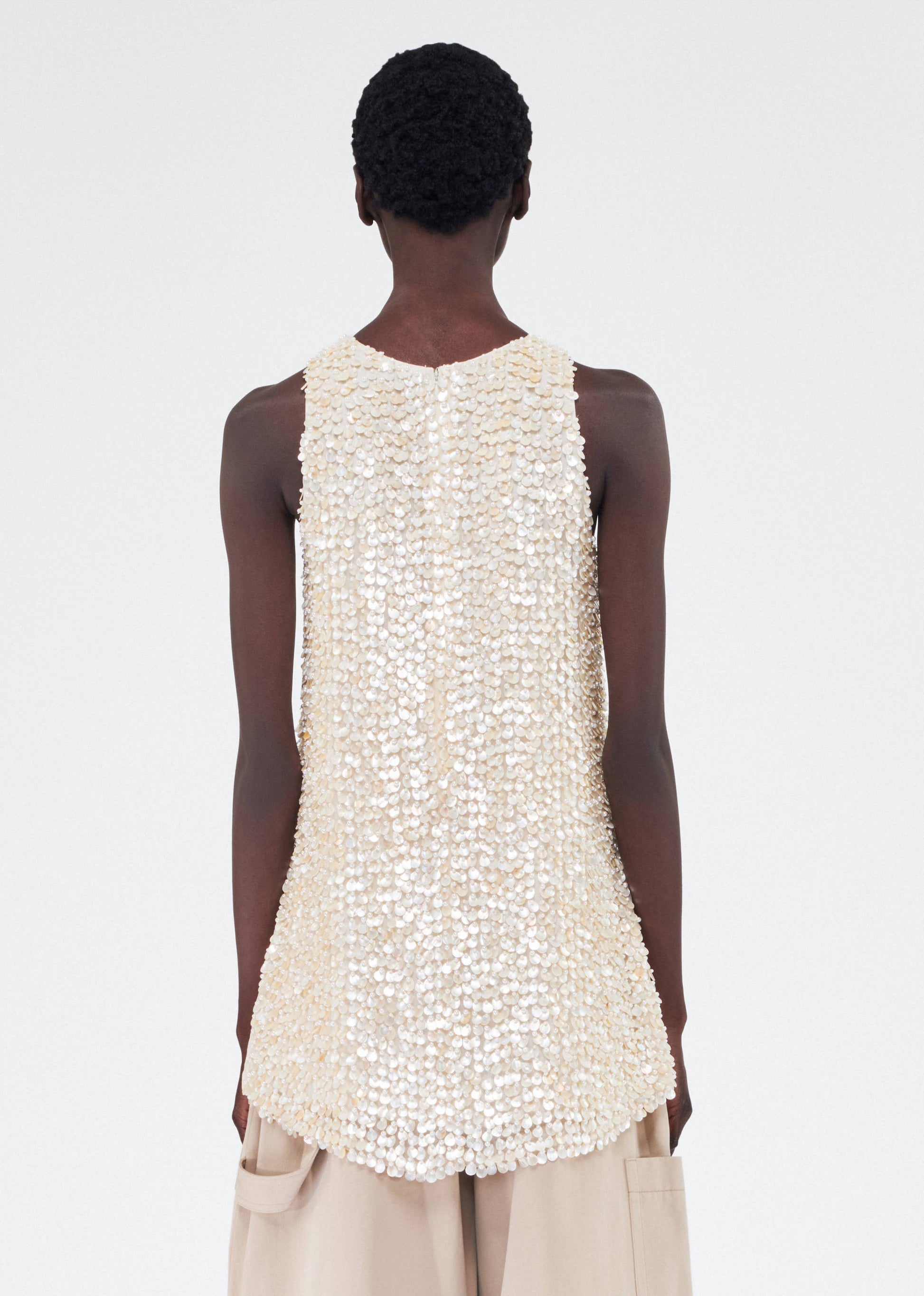 Back of model wearing the Rami Top in Embroidered Mother of Pearl
